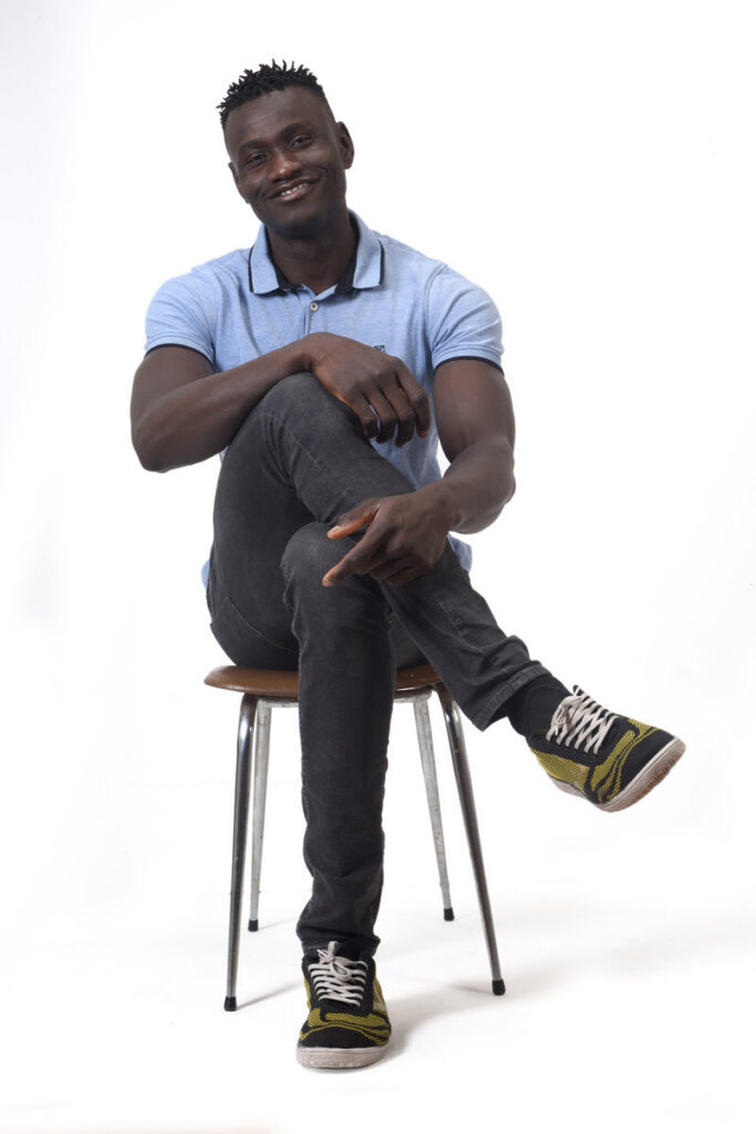 full portrait of african man sitting a chair on white background