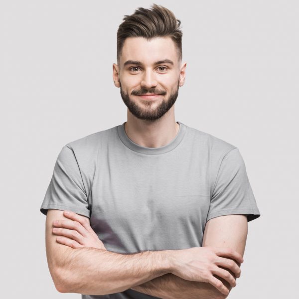 Portrait of handsome smiling young man with folded arms. Smiling