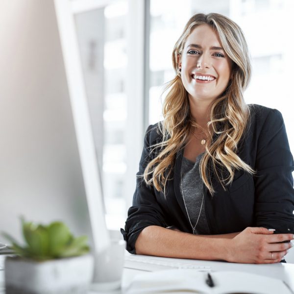 Portrait of a young businesswoman working at her desk in a modern office.