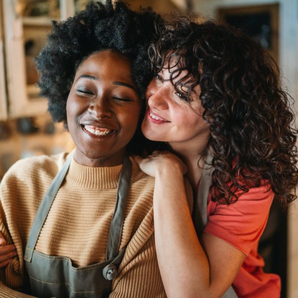 LGBT Lesbian couple love moments happiness concept. Homosexual women hugging and enjoying time together.